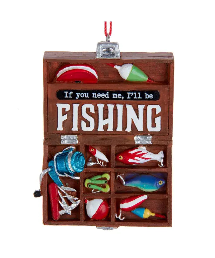 Wooden fishing tackle box with colorful fishing lures and a sign inside.