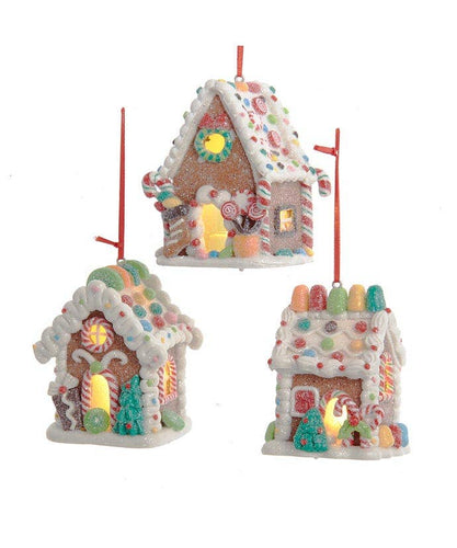 Three colorful gingerbread house ornaments on a white background