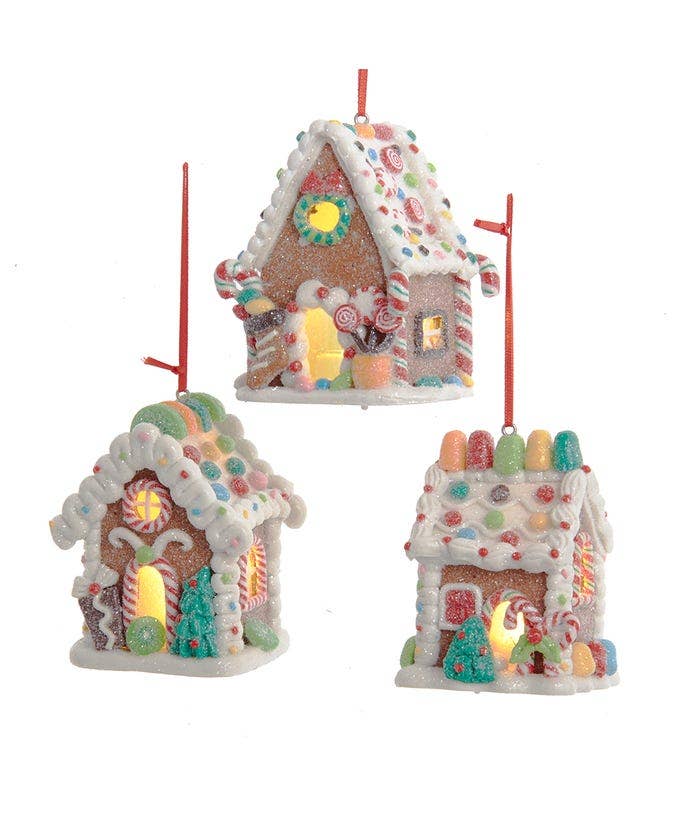 Three colorful gingerbread house ornaments on a white background