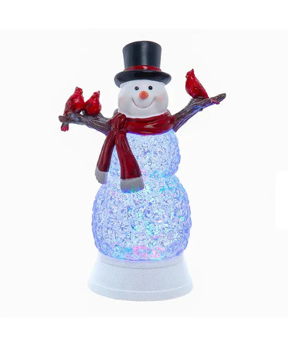 Decorative snowman figurine with red scarf and top hat holding three red birds on a white background