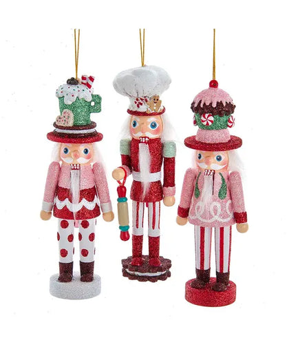Three decorative nutcracker ornaments on a white background