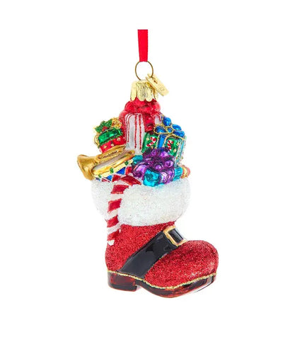 Decorative Christmas ornament shaped like a red boot with colorful gifts on a white background