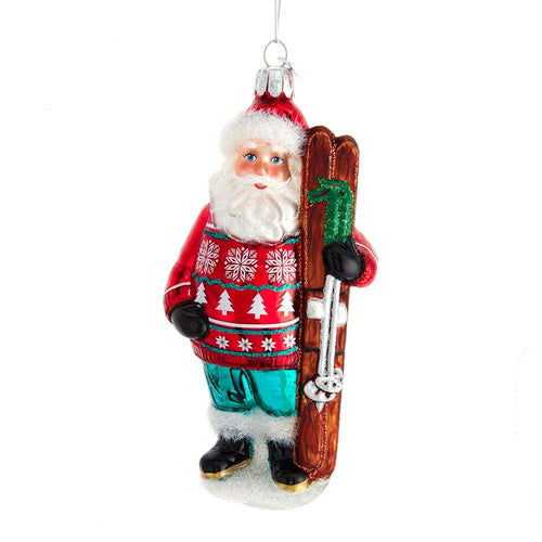 Decorative Christmas ornament of a Santa Claus holding skis on a white background