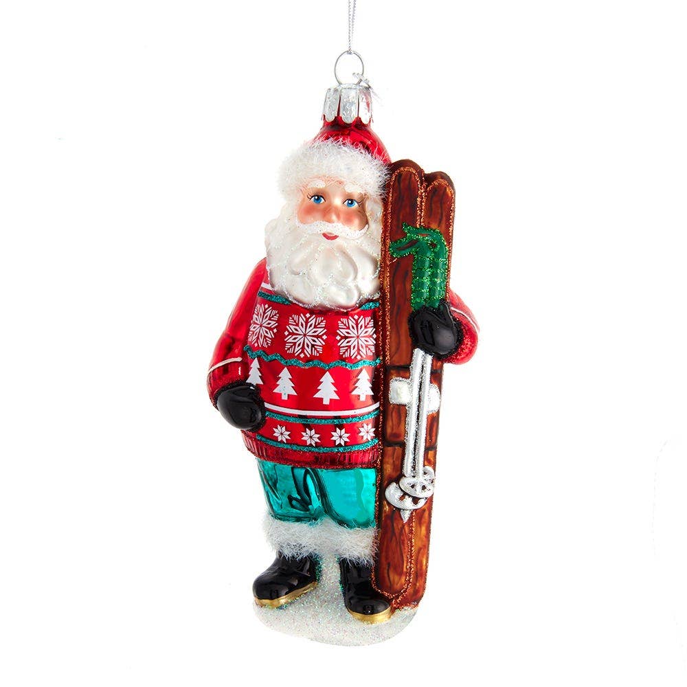 Decorative Christmas ornament of a Santa Claus holding skis on a white background