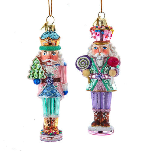 Two colorful Christmas nutcracker ornaments on a white background